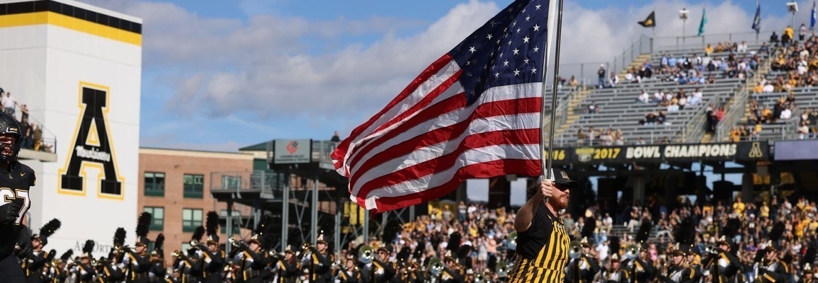 ASU Student Veteran running American flag at 2024 football game