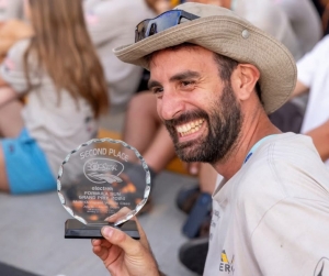 ASU Veteran John Diekmann holding the second place trophy for the 2024 Electrek American Solar Challenge with ASU Sunergy team.