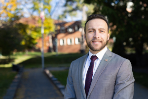 Jack Sullivan stands near Veteran Memorial on campus