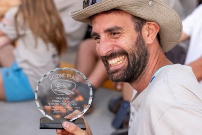 John Diekmann holding an award